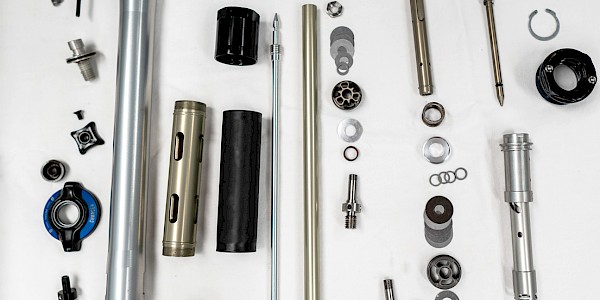 A bicycle suspension fork in pieces during the servicing and repair process