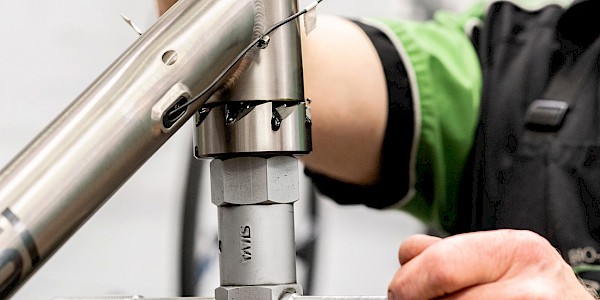 Bicycle mechanic facing and reaming a titanium bicycle frame head tube