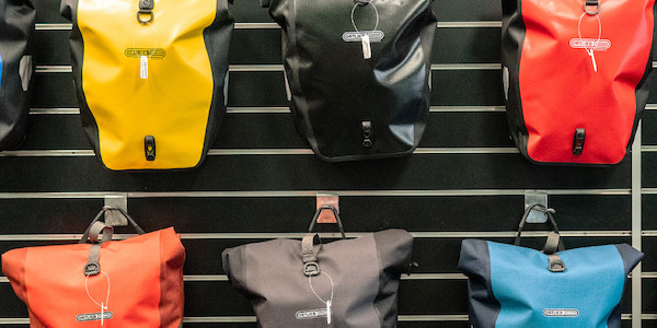 A wall full of Ortlieb Back-Roller panniers in the Classic and Plus designs