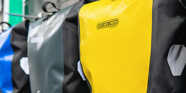 Close-up of a range of Ortlieb Back-Roller Classic panniers in Yellow, Asphalt and Blue