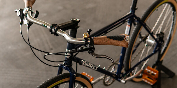 A custom-built Surly Straggler with orange accents and a pair of Ergon Biokork grips