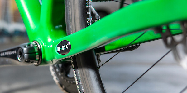 Frame detail (and BMCR sticker) on a green custom-designed carbon Plane Frameworks bike
