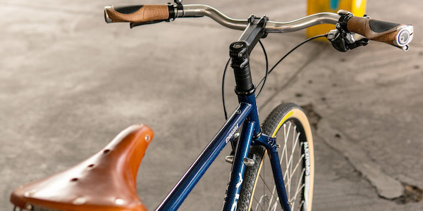 Custom-built Surly Straggler bike in Blueberry Muffintop, viewed from above and to the side, including a honey-coloured Brooks B17 leather saddle