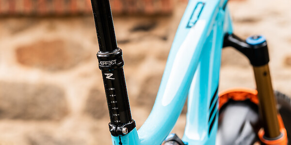 Raceface dropper post detail on an Ibis Ripmo V2 carbon mountain bike in Bug Zapper Blue