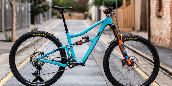Ibis Ripmo V2 carbon mountain bike in Bug Zapper Blue with some custom orange touches