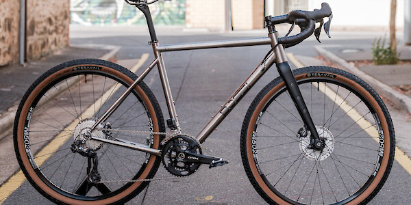 Bossi Grit SX titanium gravel bike in a custom build, shot in an alleyway