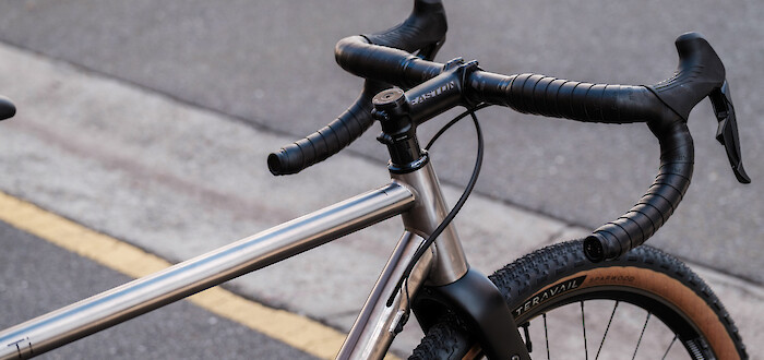 Custom-built Bossi Grit SX titanium gravel bike seen from the rear-side