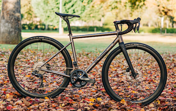 Bossi Strada titanium road bike against a backdrop of autumn leaves