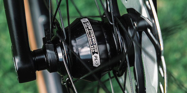Close-up of an SP dynamo hub laced into a bicycle wheel