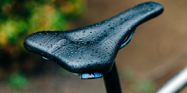 An SQ-Lab and carbon seat post fitted to a titanium Bossi Summit bicycle frame, rain droplets pooled on the top