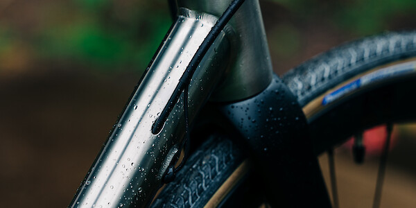 Frame detail on a rain-spattered Bossi Summit titanium road bike