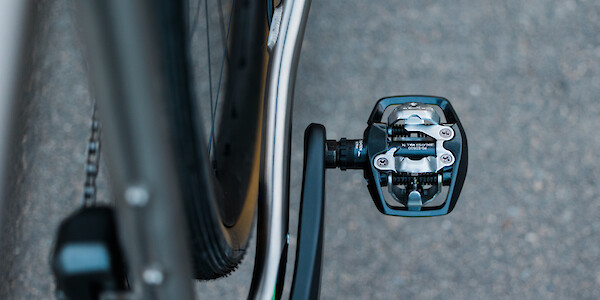 Detail of a Shimano PD-EH500 pedal on a titanium Bossi Grit gravel bike, viewed from above