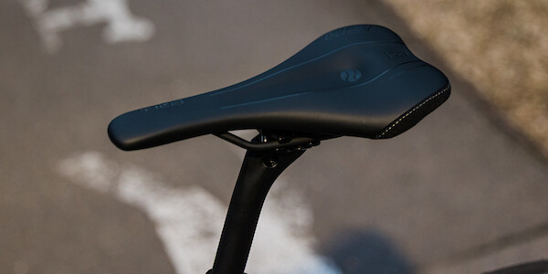 An SQ-Lab saddle and Bossi carbon seat post fitted to a titanium Bossi gravel bike, viewed from a high angle