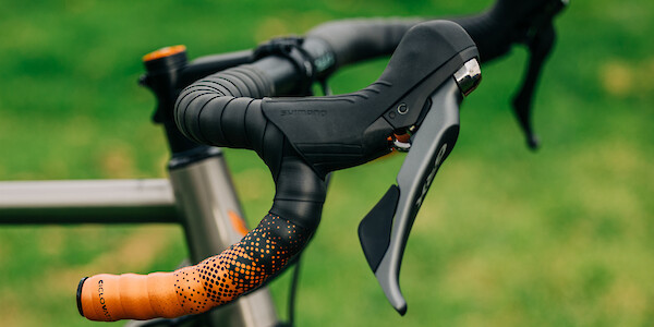 Custom-built Bossi Grit titanium bicycle, handlebar detail with orange Ciclovation bar tape