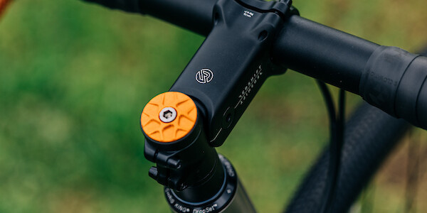 Orange Garbaruk top cap and Redshift Shockstop headstem on a custom-built Bossi Grit titanium bike