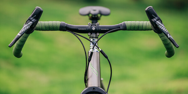 Front view of a Bossi Grit SX titanium gravel bike, including Redshift Kitchen Sink handlebars