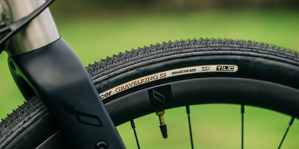 Carbon fork detail on a Bossi Grit SX titanium gravel bike, showing a Panaracer Gravelking SS tyre