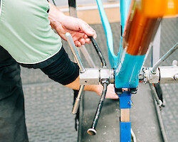 A carbon bicycle frame being professionally faced at Bio-Mechanics Cycles & Repairs' workshop by Pete, BMCR's head mechanic