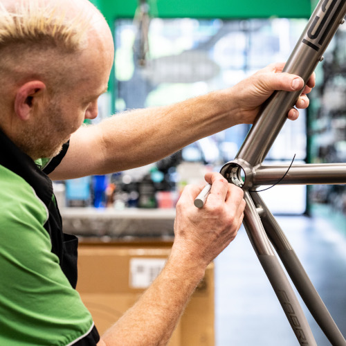 Pete from Bio-Mechanics Cycles & Repairs preparing a titanium bicycle frame for machining work