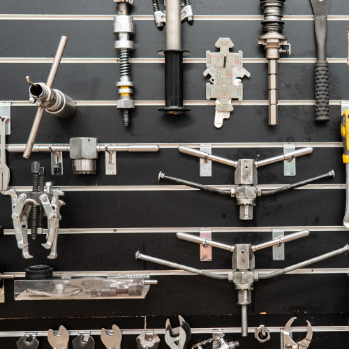 A slatwall full of professional bicycle machining and facing tools at BMCR