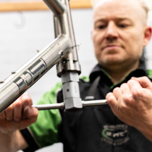 Bio-Mechanics Cycles & Repairs's head mechanic Pete using a facing tool on a titanium bicycle frame