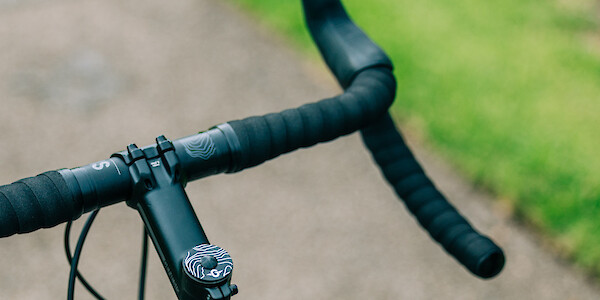 Genesis Vagabond bicycle, handlebar detail, viewed at an angle from the rear