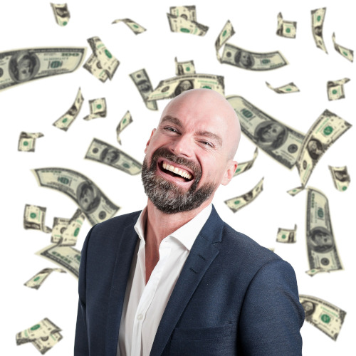 A bearded man grinning with joy against a backdrop of falling money.