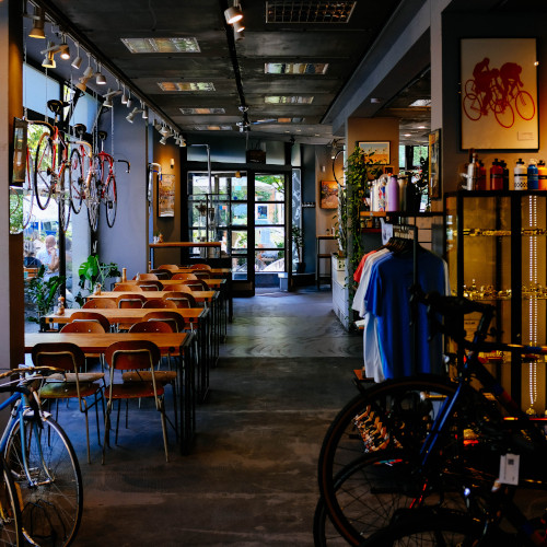 Interior of a shop which seems to sell mostly bicycles and coffee. It is very neat, and also deserted. Perhaps the lattes are very expensive.