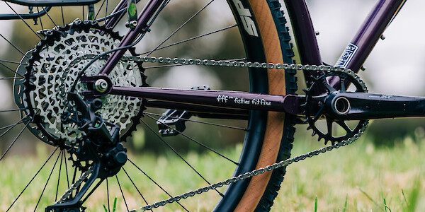 Drivetrain detail on a custom-built Surly Karate Monkey bike in Eggplant, featuring a Shimano XT groupset and Garbaruk components.