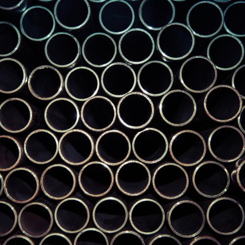 A rack of metal tubes, seen from the open ends