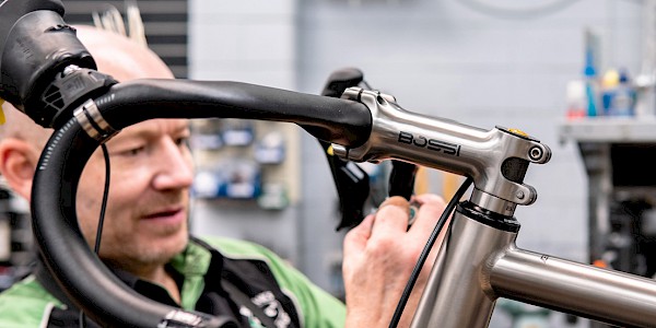 Bicycle mechanic servicing a Bossi bicycle