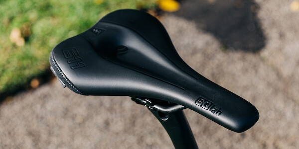 SQLab 611 saddle fitted to a bicycle, viewed from above, photographed outdoors on a parklands pathway.