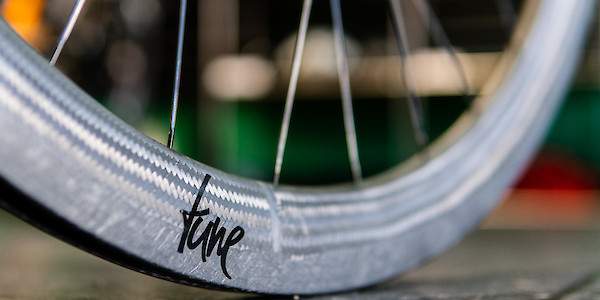 Tune carbon rim detail, sitting on a black concrete surface