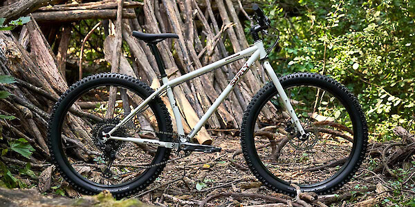 Surly Karate Monkey bike in Snow Mould White, shot against a wooded backdrop