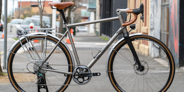 Bossi Grit titanium bicycle in a custom commuter build, shot on a city footpath