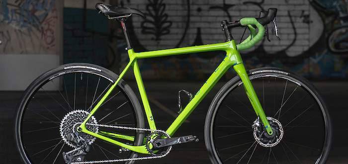 Open Cycles UP custom build in lime green, shot against a dark background