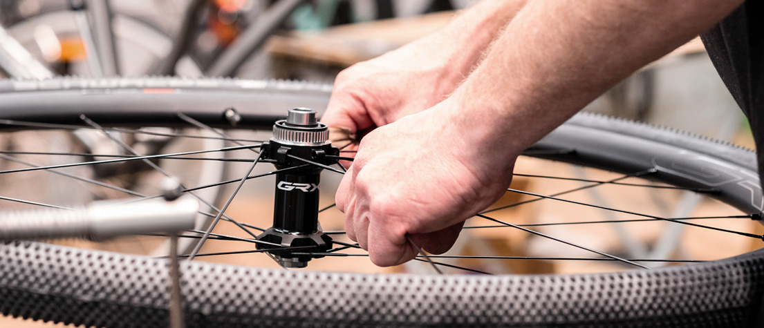 A professional bicycle mechanic working on a wheel at Bio-Mechanics Cycles & Repairs