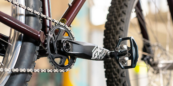 Chain and crankset detail on a Surly Krampus mountain bike in Pickled Beet