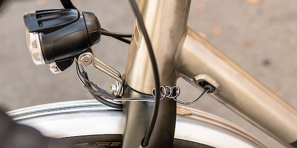 A dynamo front light built into a custom Bossi Grit titanium bicycle