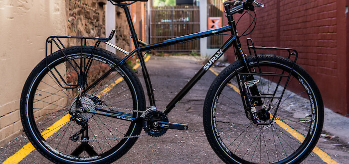 A black Surly Ogre touring bicycle, custom-built, in a narow alleyway