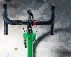 A green road bicycle, viewed from above.