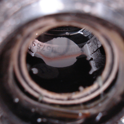 Close-up of a pool of water inside a bicycle frame's bottom bracket shell
