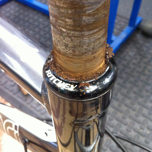 A bicycle fork steerer encrusted with rust