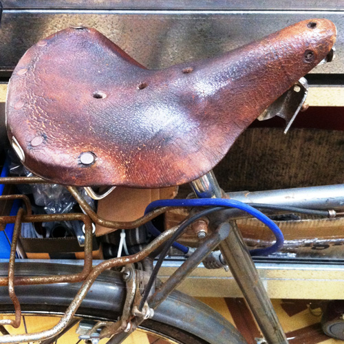 A leather Brooks bicycle saddle which has been ruined by neglect