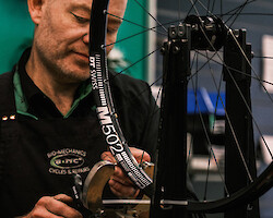 A bicycle mechanic building a wheel at Bio-Mechanics Cycles & Repairs