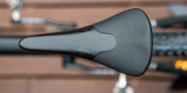 A carbon Tune Komm Vor Plus saddle fitted to a Ibis Cycles DV9 mountain bike, viewed from above