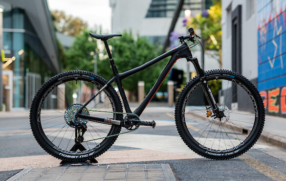 Ibis Cycles DV9 carbon mountain bike in a custom build, shown in a deserted university campus