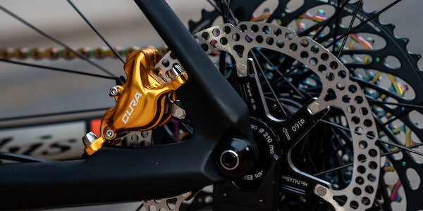 Close-up of a gold Formula Cura rear brake on a carbon Ibis Cycles DV9 hardtail mountain bike