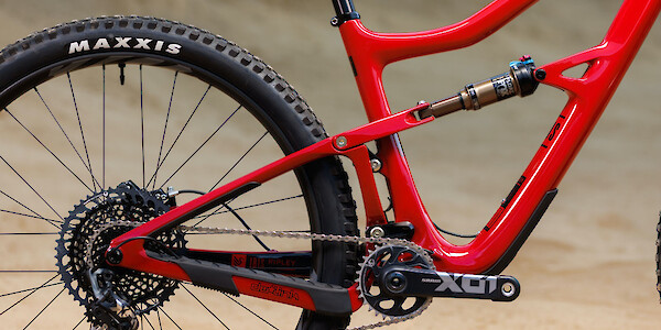 Drivetrain and rear shock detail on an Ibis Ripley V4S mountain bike in Bad Apple Red