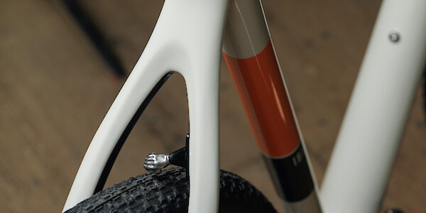 Rear triangle and removable fender mount detail on an Ibis Hakka MX bicycle in Saltwater Taffy. The mount is in the shape of a small hand; it's very cute.